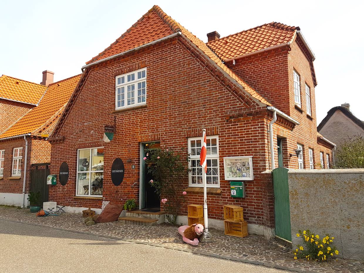 Wohnhaus mit einem Laden, Dannebbrog und etwas Deko vor der Tür
