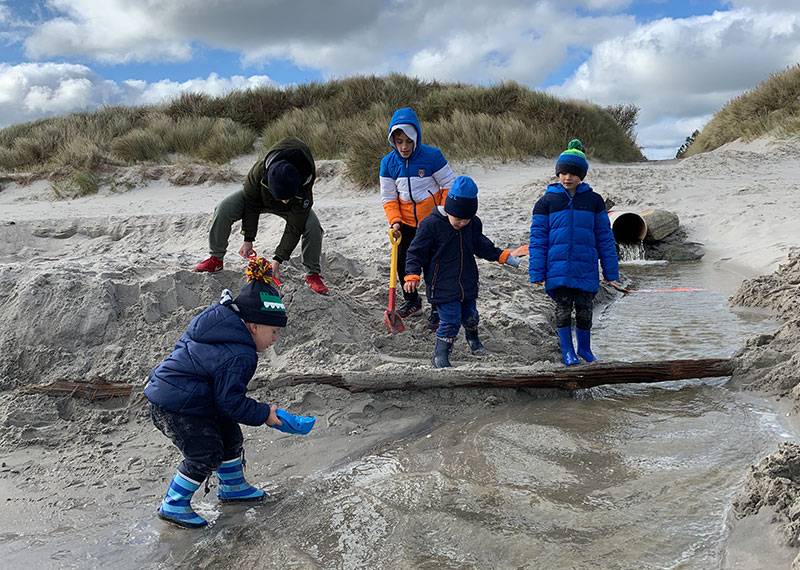 Kinder bauen am Strand