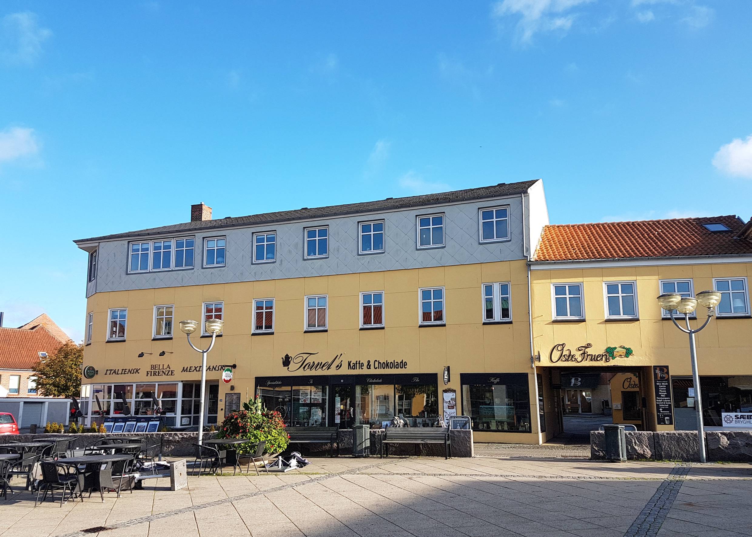 Zwei gelbe Häuser mit Geschäften am Marktplatz