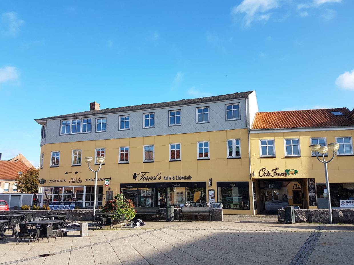 Zwei gelbe Häuser mit Geschäften am Marktplatz