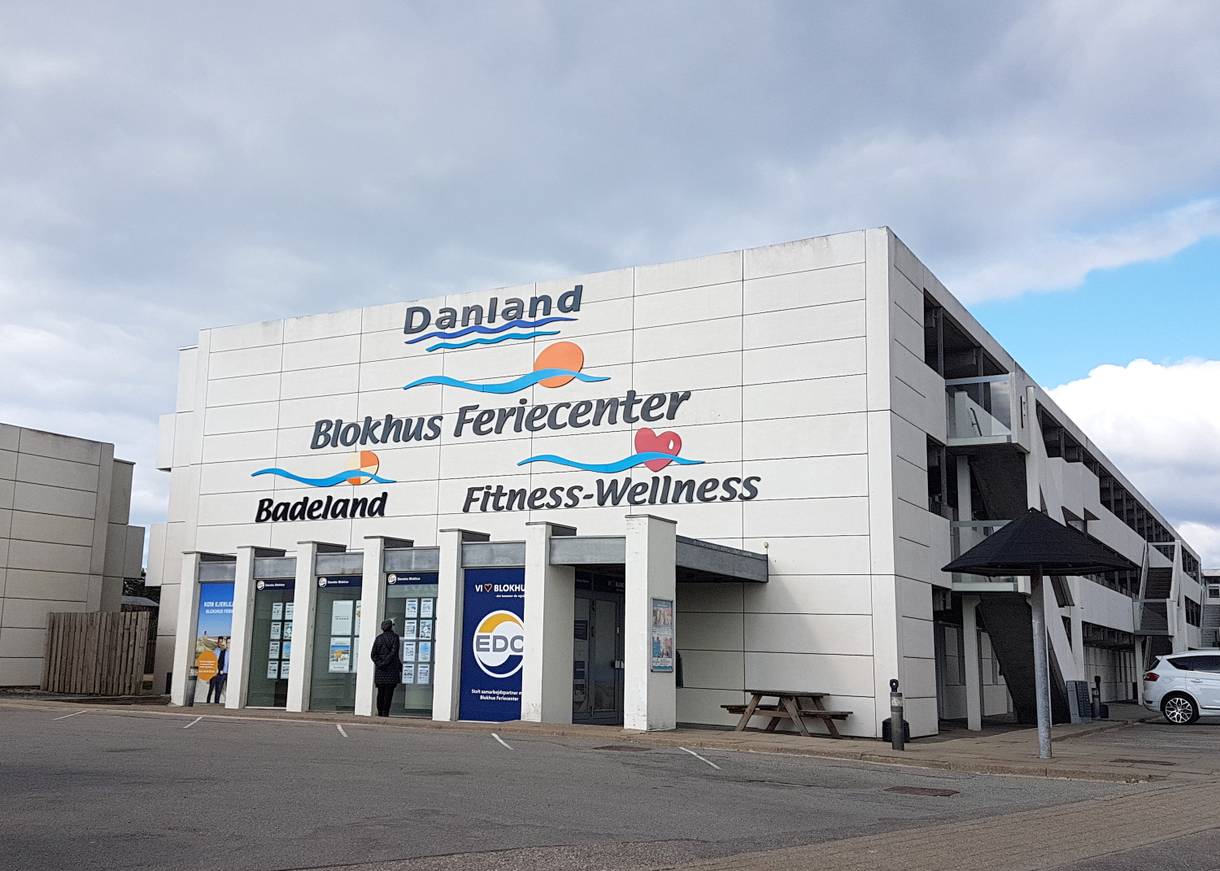 Weißes Gebäude mit Werbung für ein Feriencenter