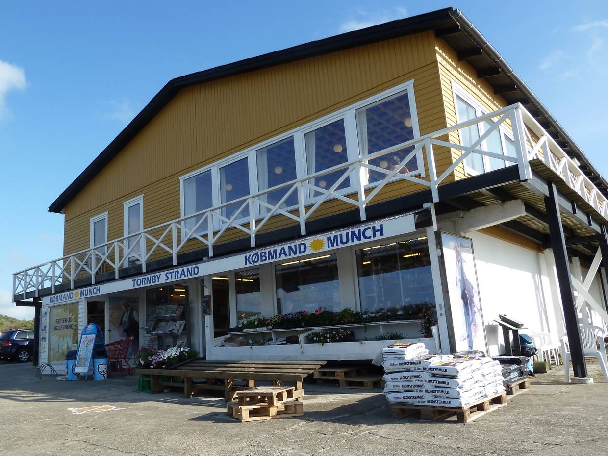 Haus mit einem Geschäft unten und im Obergeschoss ein Restaurant mit weißer Terrassenbrüstung