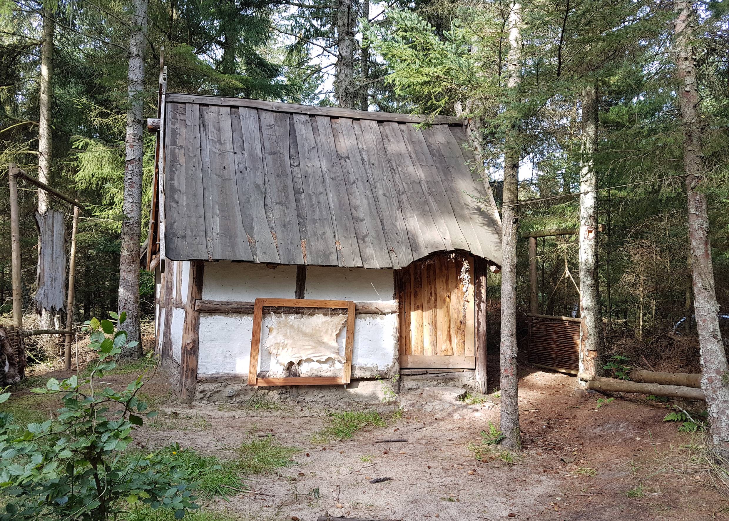 Kleines Fachwerkhaus mit Holzdach im Wald