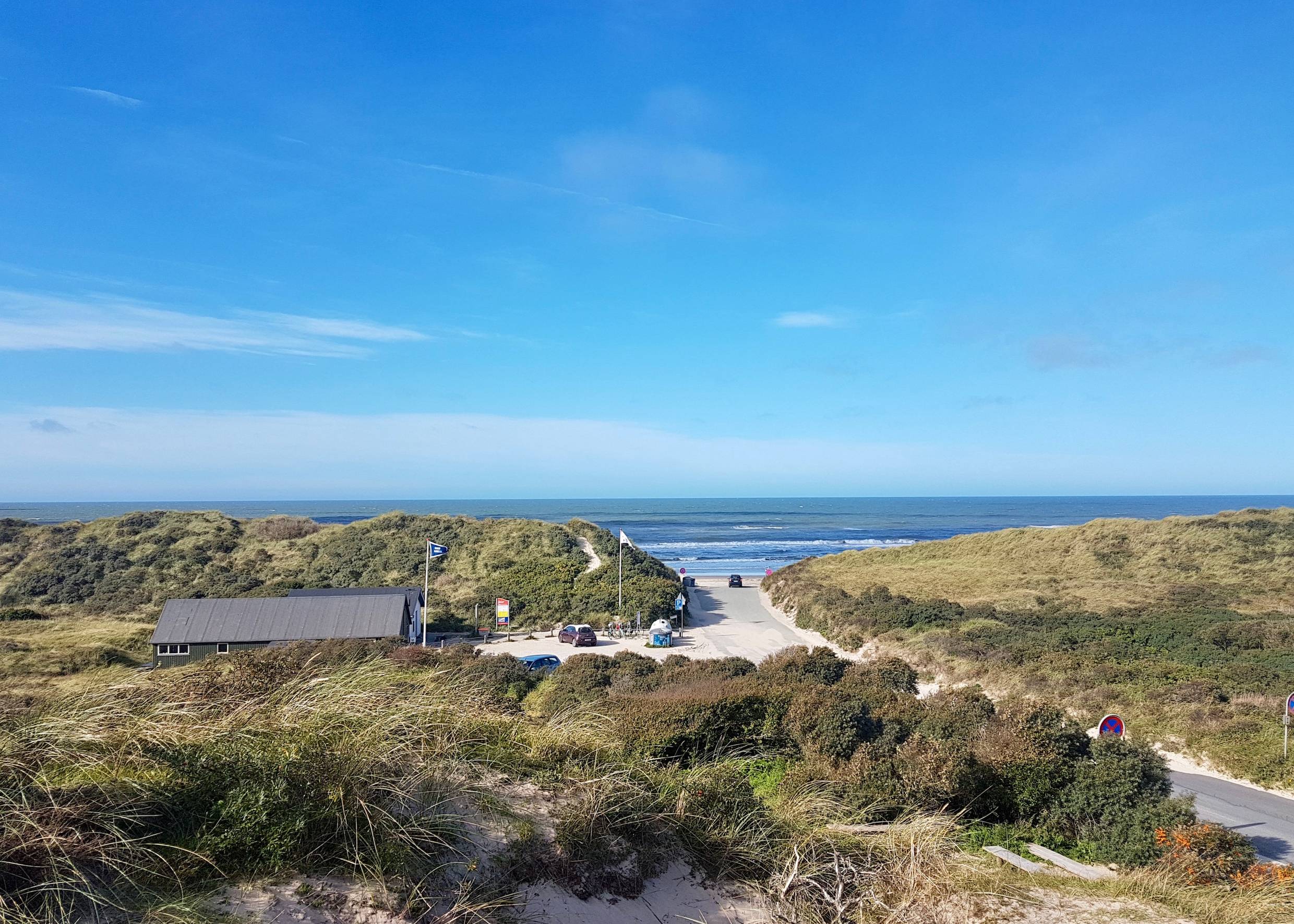 Blick von einer Düne auf den Parkplatz und die Strandzufahrt in Tversted 