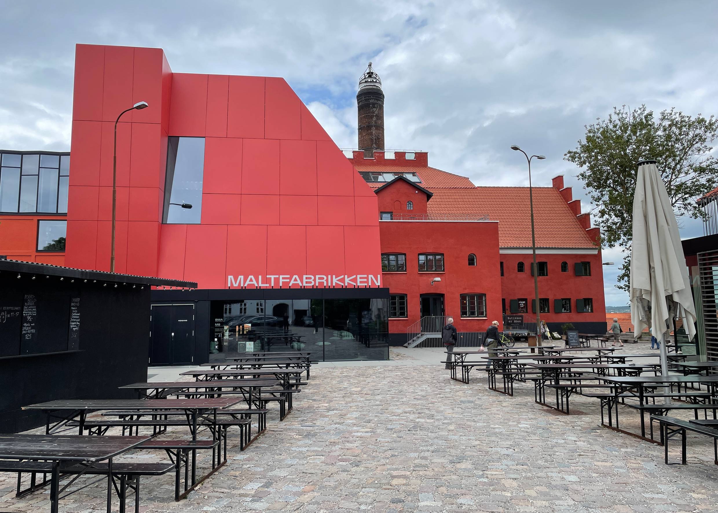 Die Alte Malzfabrik mit Holztischen davor
