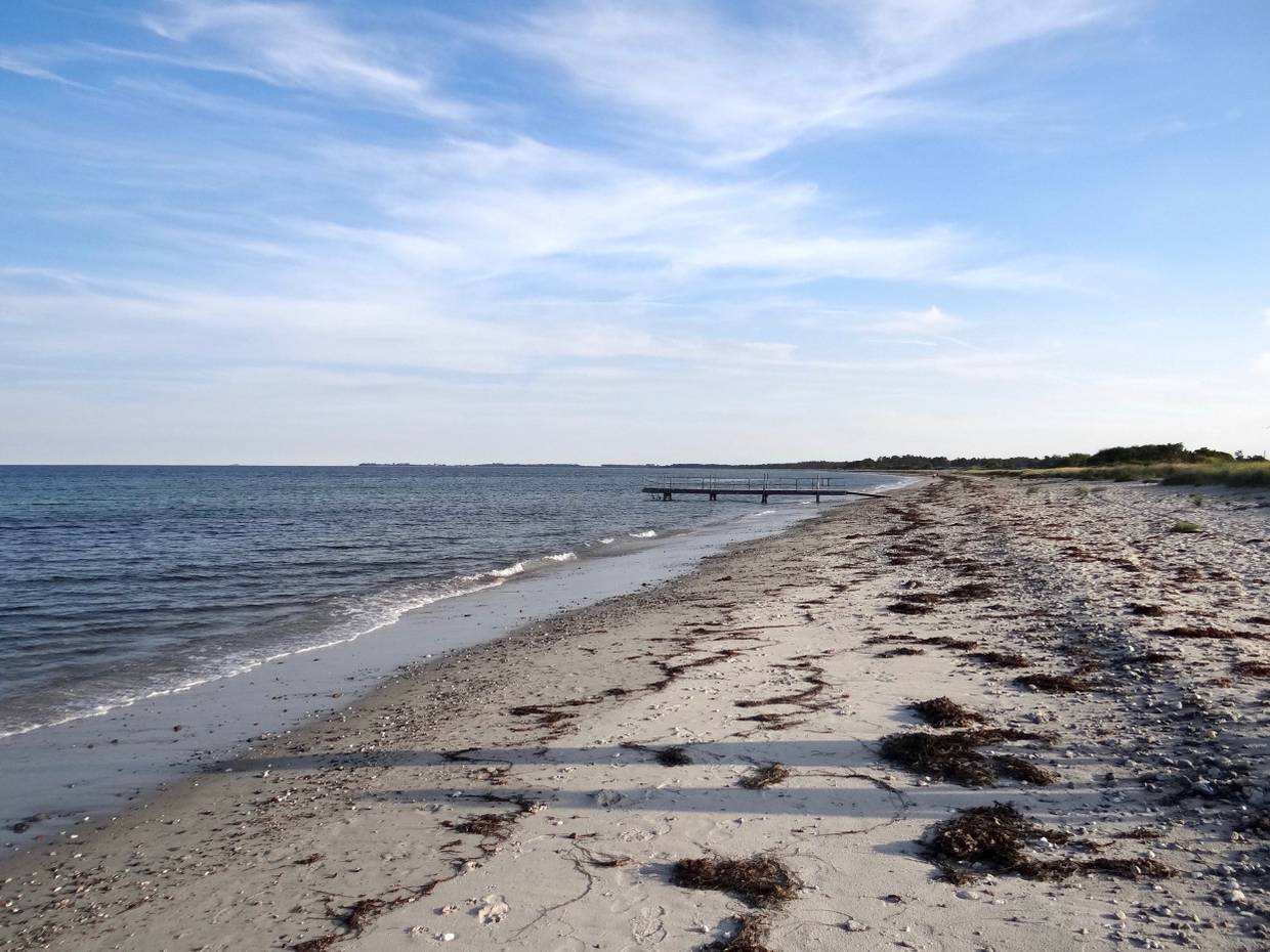 Weißer Sandtrand auf Samsø mit einem Badesteg