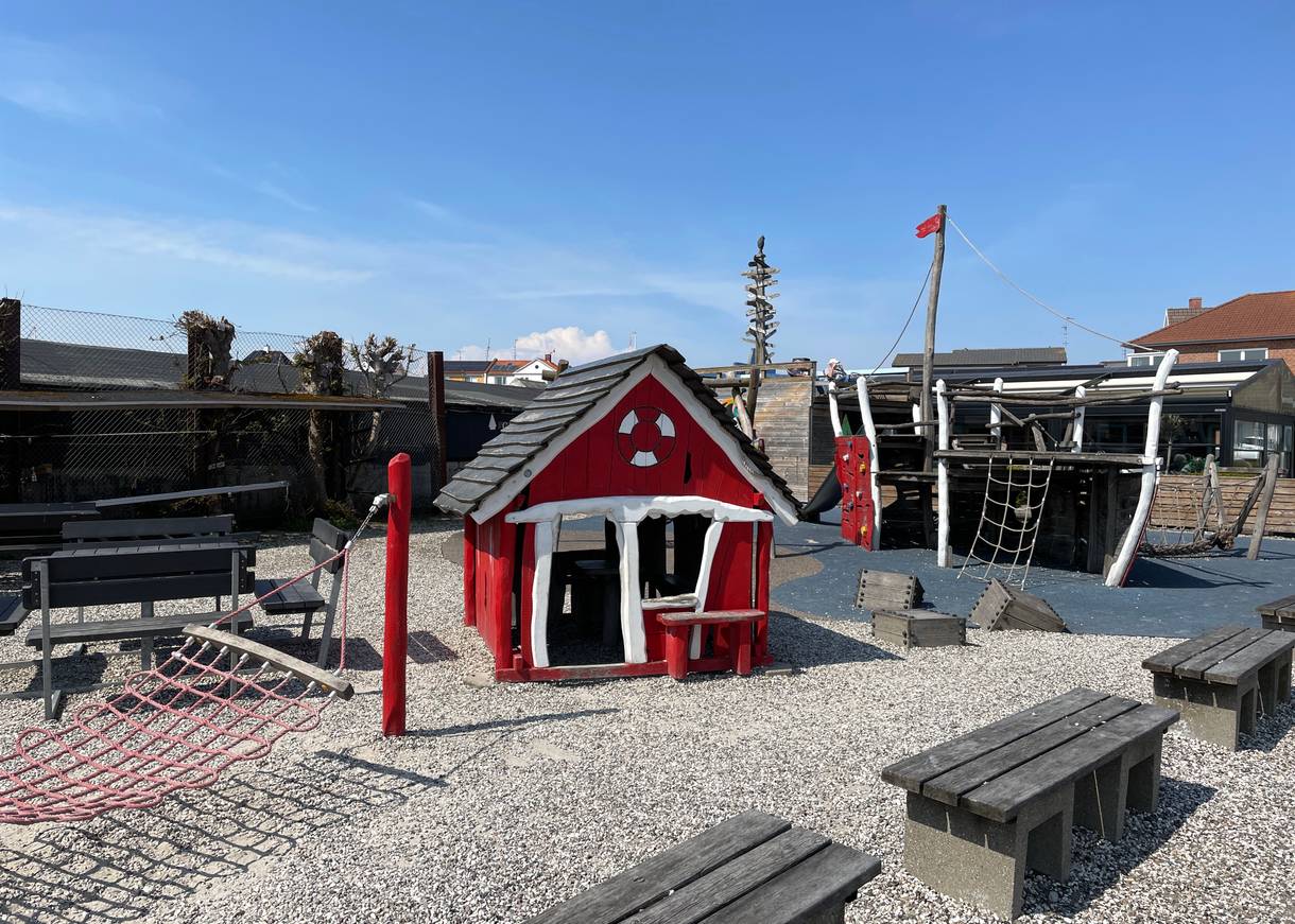 Rotes Holzhäuschen auf einem Spielplatz