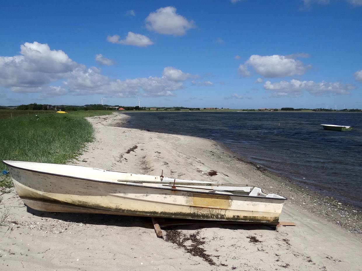 Ruderboot auf einem schmalen Sandstrand