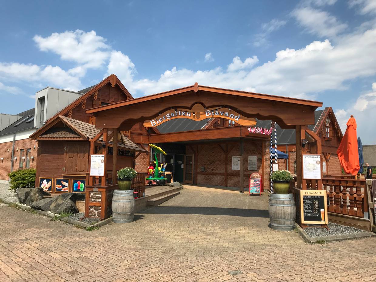 Gebäude mit einem hölzernem Eingang mit der Aufschrift Biergarten