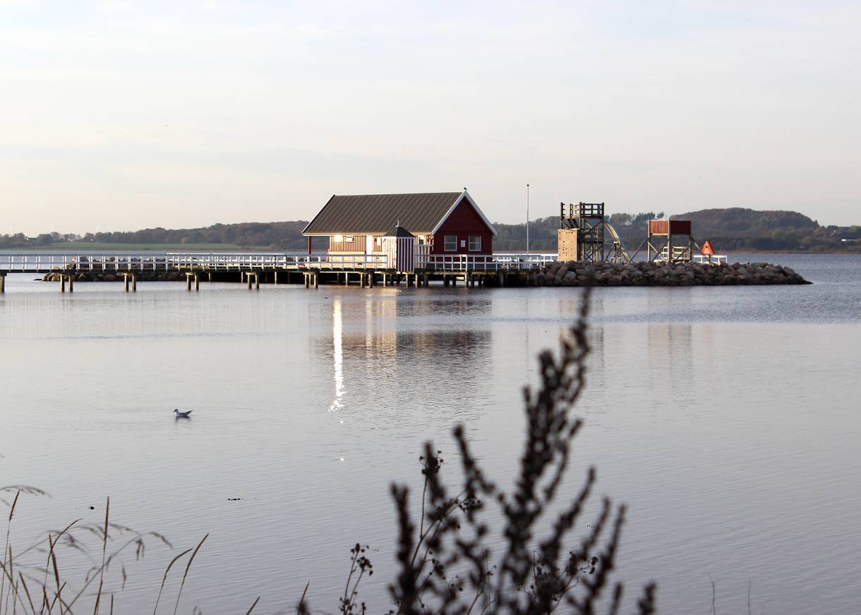 Holzhaus im Wasser an einem langen Steg
