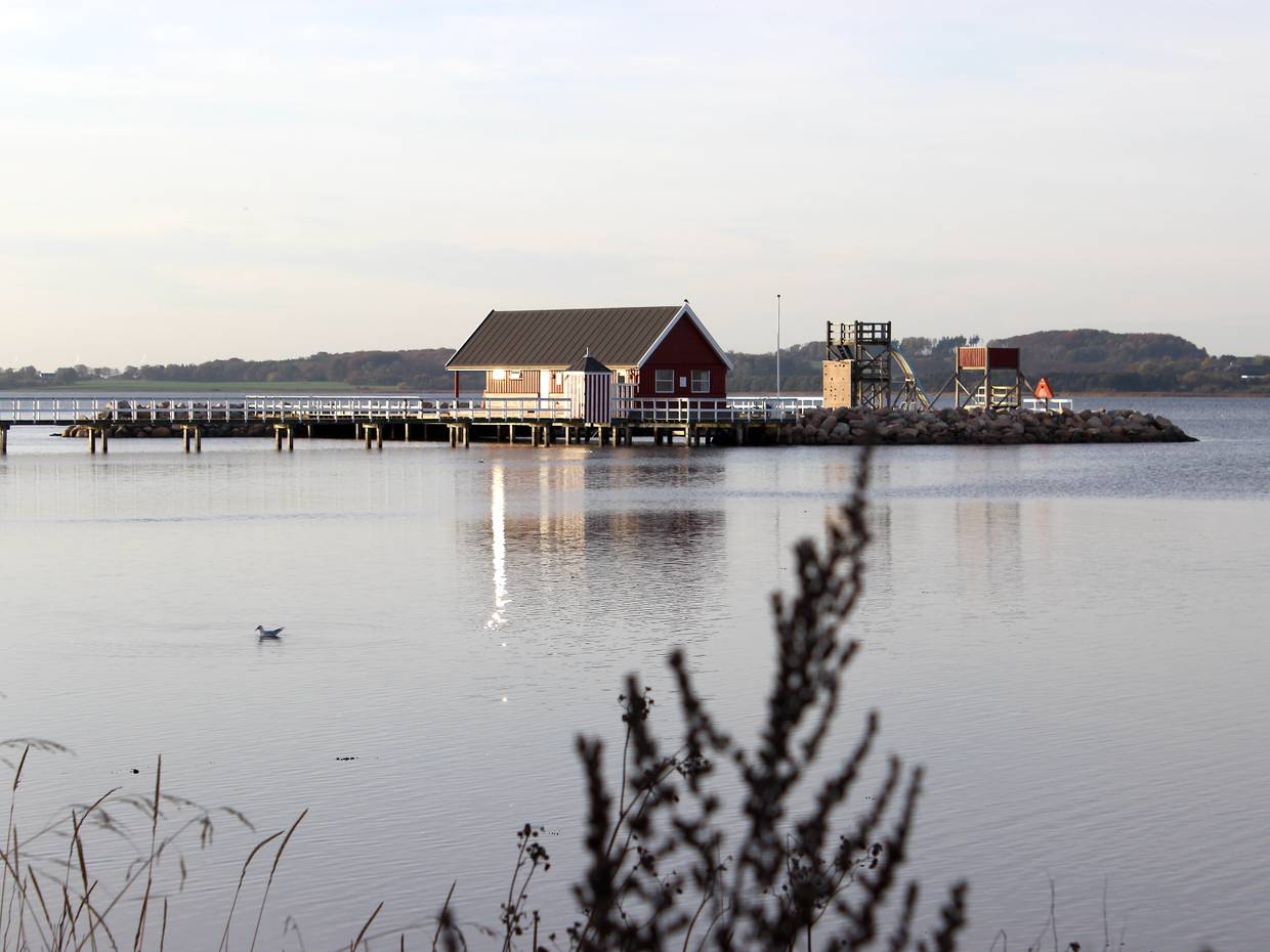 Holzhaus im Wasser an einem langen Steg